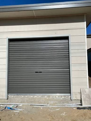 Grey roller door in a new build